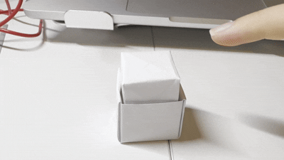 I pressed the folded paper button by hand to check how much movement and resistance it had.