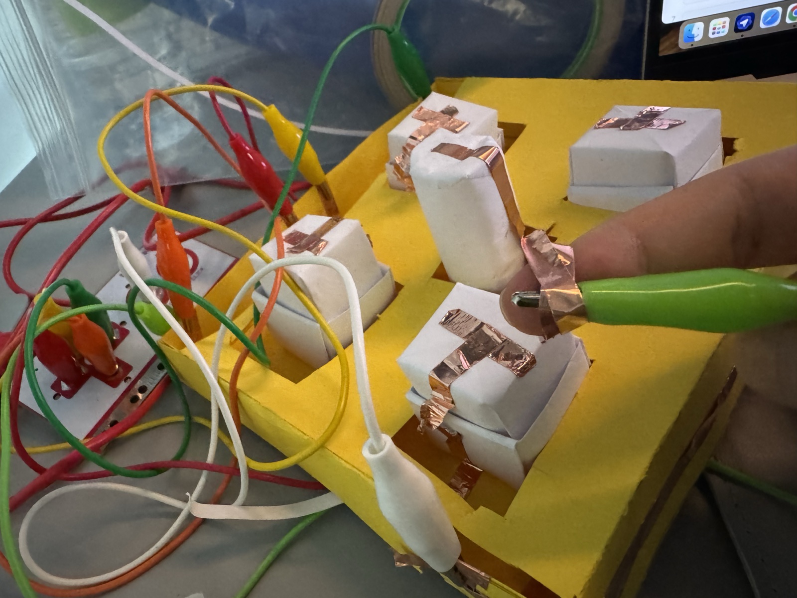 This close-up records the final controller during play, with the clips, conductive tape, and paper buttons all working together.